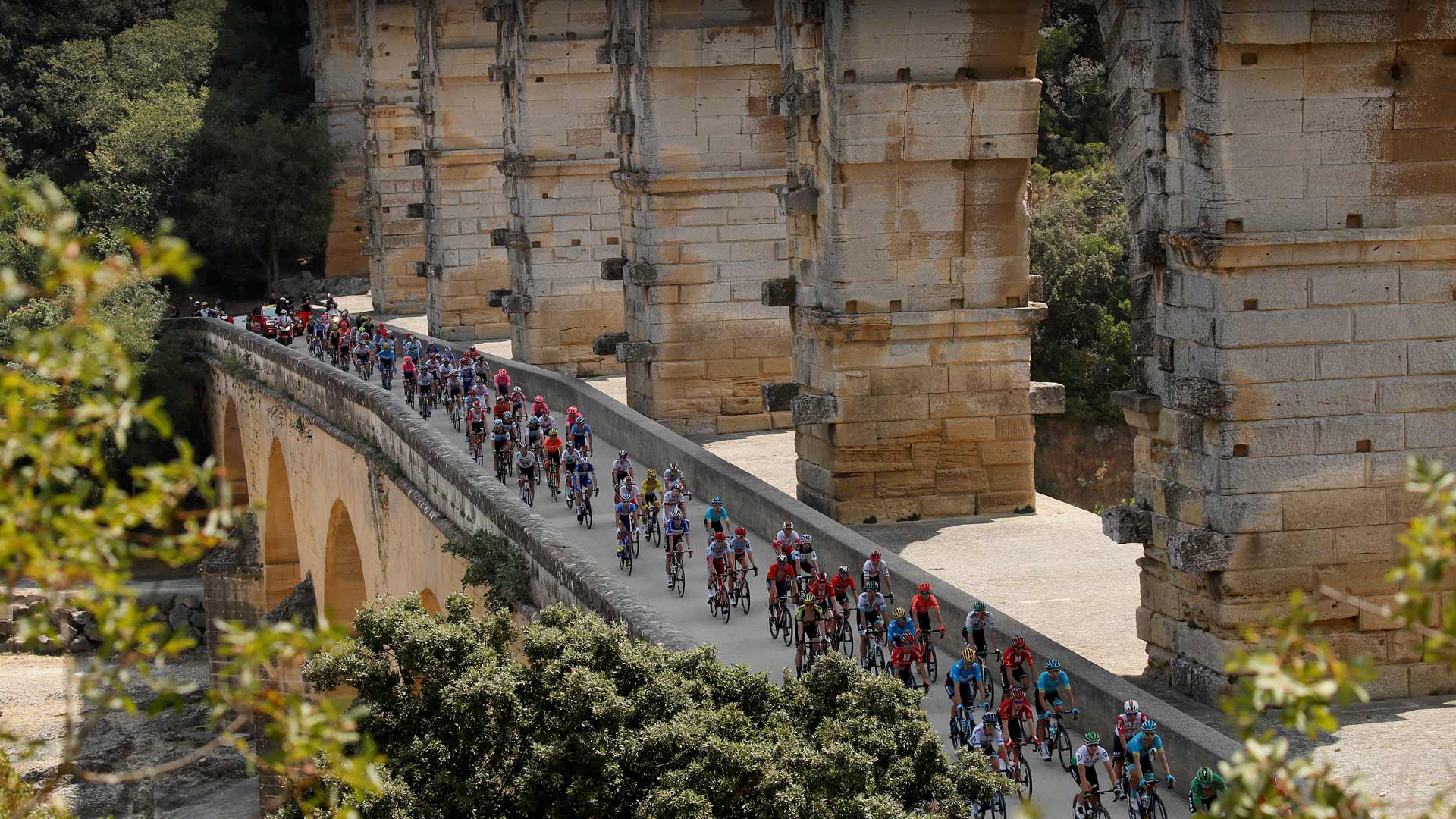 Tour de France cyclists crossing the Pont du Gard