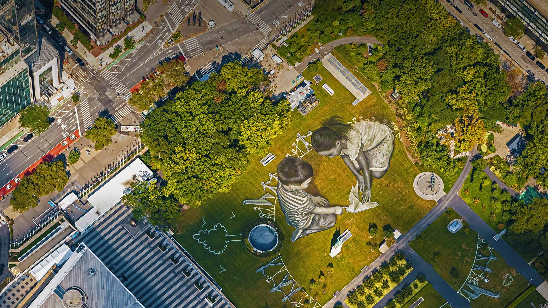 Land art painting entitled 'World in Progress II' by artist Saype at the Headquarters of the United Nations in New York City
